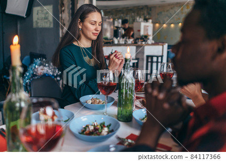 Friends Saying Prayer Before Eating Meal Together. Friends Saying Prayer Before Eating Meal Together. 84117366