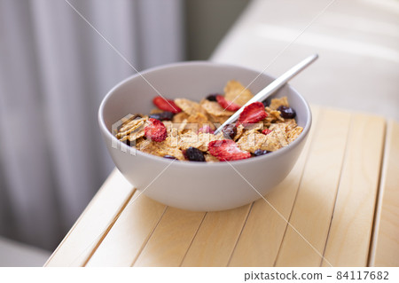 Corn flakes in white bowl Corn flakes in white bowl 84117682