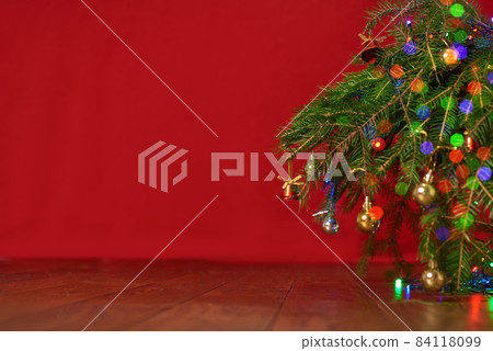 red background, christmas tree, spruce branches with New Year's toys, background for a New Year card 84118099