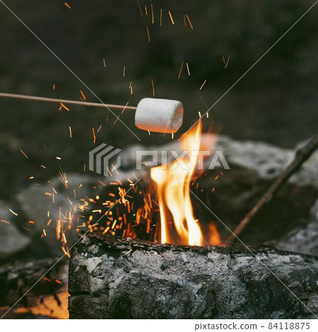 person burning marshmallows camp fire 2. High quality beautiful photo concept person burning marshmallows camp fire 2. High quality beautiful photo concept 84118875