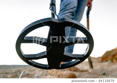 Metal detector coil in action above the ground Metal detector coil in action above the ground 84118879