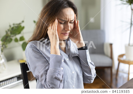 Young tired working woman at home office Young tired working woman at home office 84119385
