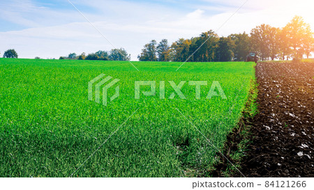 Tractor agriculture. Agriculture farm machinery on landscape land field. Farmer machine equipment for crop. Landscape tractor concept. Tractor agriculture. Agriculture farm machinery on landscape land field. Farmer machine equipment for crop. Landscape tractor concept. 84121266
