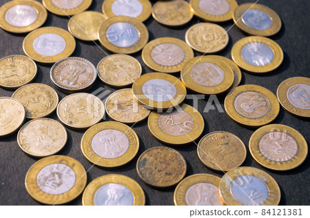 Heap of Gold Colored Indian Rupee Coin currency on rustic floor. Full Frame. High Angle View. Business Finance and financial Investment Background. Close Up Heap of Gold Colored Indian Rupee Coin currency on rustic floor. Full Frame. High Angle View. Business Finance and financial Investment Background. Close Up 84121381