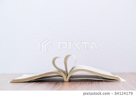 concept of reading a book is at the desk in the room 84124179