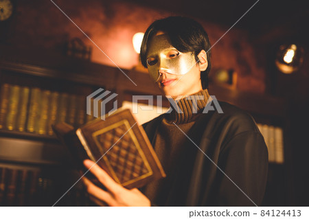 A man wearing a mask in his study 84124413