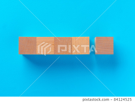 Top view of wooden toy blocks on blue 84124525