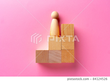 Top view of toy wooden blocks on pink 84124526