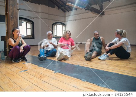 Seniors sitting on floor in dance studio 84125544