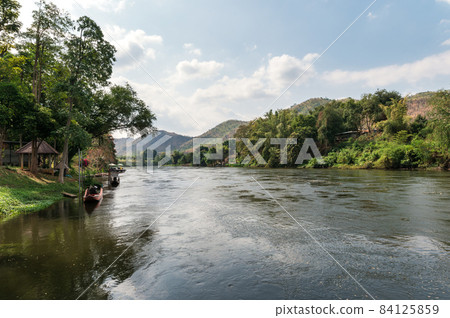 Scenery of mountain and water flowing on riverside at River Kwai 84125859