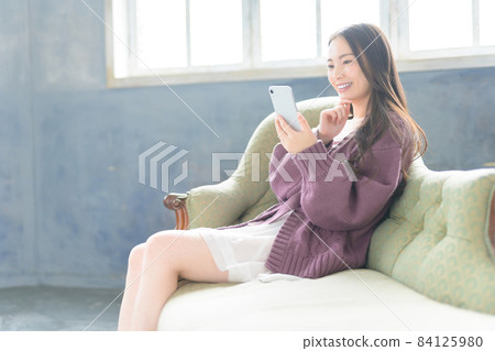 A smartphone and a woman 84125980