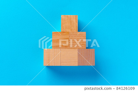 Top view of wooden toy blocks on blue Top view of wooden toy blocks on blue 84126109