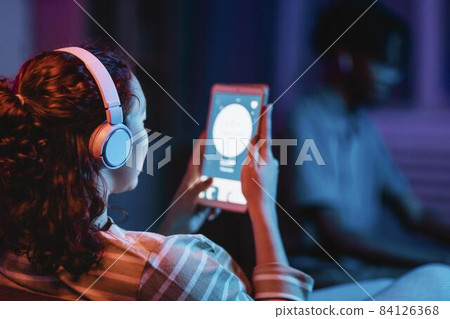 back view woman home using headphones tablet. High quality beautiful photo concept 84126368