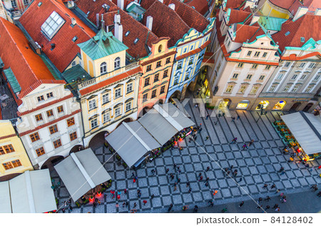 Top aerial panoramic view of Prague Old Town Stare Mesto historical city centre with red tiled roof buildings Top aerial panoramic view of Prague Old Town Stare Mesto historical city centre with red tiled roof buildings 84128402