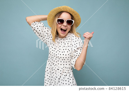 Photo of young positive happy attractive blonde woman with sincere emotions wearing summer dress Photo of young positive happy attractive blonde woman with sincere emotions wearing summer dress 84128615