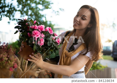 European beautiful attractive brunette female person wearing stylish white t-shirt and blue jeans European beautiful attractive brunette female person wearing stylish white t-shirt and blue jeans 84128634