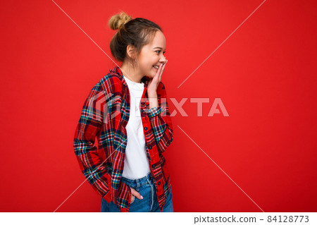 Photo of young positive happy surprised beautiful blonde woman with sincere emotions wearing red Photo of young positive happy surprised beautiful blonde woman with sincere emotions wearing red 84128773