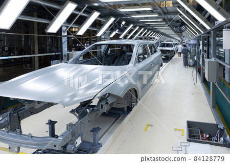 Car bodies are on assembly line. Factory for production of cars. Modern automotive industry 84128779