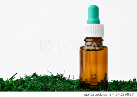 Bottle of aromatic oil for herbal medicine among natural green moss Bottle of aromatic oil for herbal medicine among natural green moss 84129087