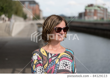 Portrait of a white woman standing at the canal Portrait of a white woman standing at the canal 84129113