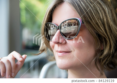 Summer portrait of an atrtactive white woman outdoors 84129119