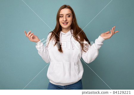 Photo of young positive happy beautiful brunette woman with sincere emotions wearing white hoodie Photo of young positive happy beautiful brunette woman with sincere emotions wearing white hoodie 84129221