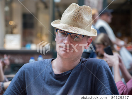Portrait of a confident 40 year old man with a summer hat Portrait of a confident 40 year old man with a summer hat 84129237