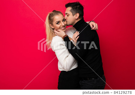 Photo of a beautiful positive smiling young blonde woman white knitted sweater and an adult brunet 84129278