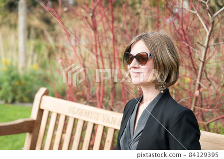 Portrait of thirty year old woman with sunglasses, posing in an autumn park Portrait of thirty year old woman with sunglasses, posing in an autumn park 84129395