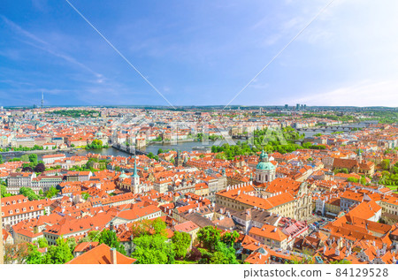 Top aerial panoramic view of Prague historical city centre with red tiled roof buildings in Mala Strana Top aerial panoramic view of Prague historical city centre with red tiled roof buildings in Mala Strana 84129528