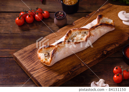 Delicious fresh street pizza with chicken, mushrooms and cheese 84131150