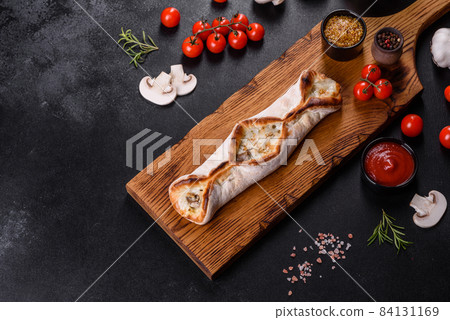 Delicious fresh street pizza with chicken, mushrooms and cheese 84131169