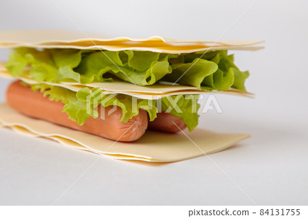 A sandwich made from raw lasagna leaves, lettuce and sausages. A sandwich made from raw lasagna leaves, lettuce and sausages. 84131755