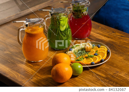 fruit and berry lemonades on the wooden tray with spruce. fruit and berry lemonades on the wooden tray with spruce. 84132087