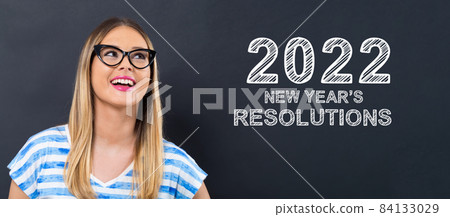 2022 New Years Resolutions with happy young woman 84133029