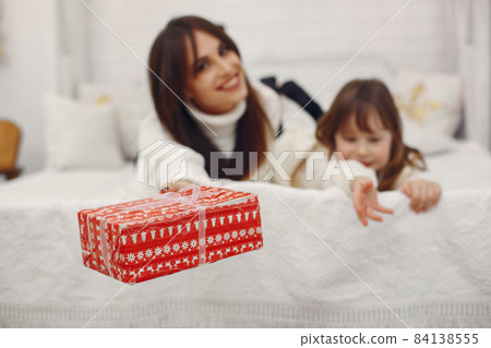 Mother with cute daughter at home with christmas gifts Mother with cute daughter at home with christmas gifts 84138555