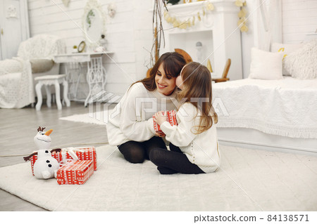 Mother with cute daughter at home with christmas gifts Mother with cute daughter at home with christmas gifts 84138571