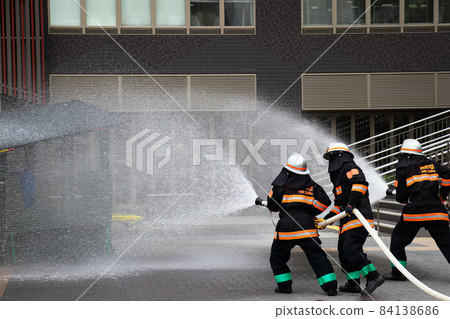 Fire extinguishing training by water discharge by firefighters Fire extinguishing training by water discharge by firefighters 84138686