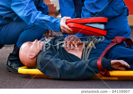 Firefighters conducting emergency lifesaving training by AED using rescue mannequins Firefighters conducting emergency lifesaving training by AED using rescue mannequins 84138907