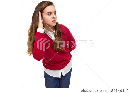 Photo of beautiful cute charming brunette teenage girl with long hair in stylish red sweater and 84140341