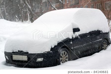 Car covered with thick snow after heavy snowfall. Car covered with thick snow after heavy snowfall. 84140681