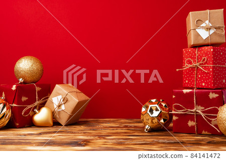 Christmas gift boxes against red background front view 84141472