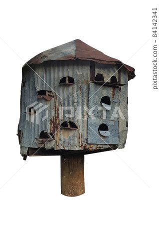 The pigeon house is a multi-tiered round of galvanized tin with a conical roof on a single pole on a white background The pigeon house is a multi-tiered round of galvanized tin with a conical roof on a single pole on a white background 84142341