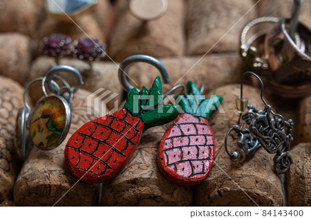 Different jewelry is stuck in a stand of wine corks Different jewelry is stuck in a stand of wine corks 84143400