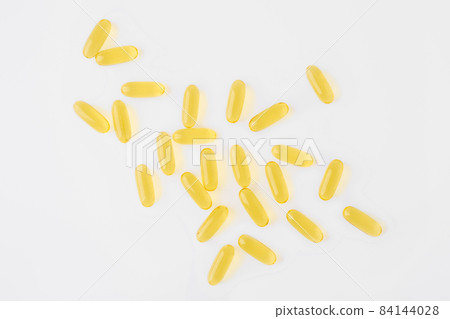 Overhead view of omega 3 capsule scattered on white background Overhead view of omega 3 capsule scattered on white background 84144028