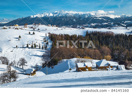 Fabulous winter scenery with mountains and Pestera village, Romania 84145160