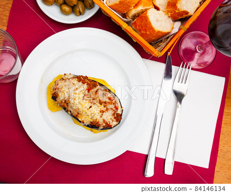 Image of a stuffed eggplant with cheese baked on top Image of a stuffed eggplant with cheese baked on top 84146134