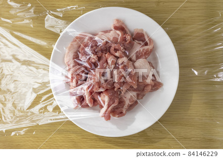 Pork on a plate and wrapped 84146229