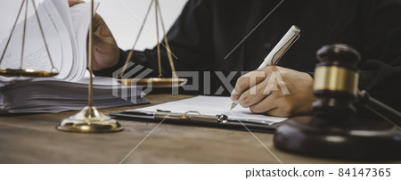 Law theme, mallet of the judge, law enforcement officers, evidence-based cases, and documents taken into account. 84147365