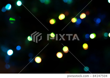 Defocused bokeh lights on black background, an abstract naturally blurred backdrop for Christmas eve or birthday party. Festive light texture. Colorful garland in blur. Overlay effect for design Defocused bokeh lights on black background, an abstract naturally blurred backdrop for Christmas eve or birthday party. Festive light texture. Colorful garland in blur. Overlay effect for design 84147504